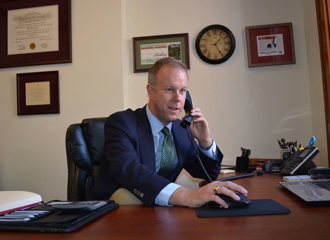 We Are Independent - Joseph H. Deacon III Aswering a Call While Sitting at His Desk in the Office